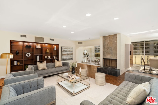 living room featuring light parquet floors and a fireplace