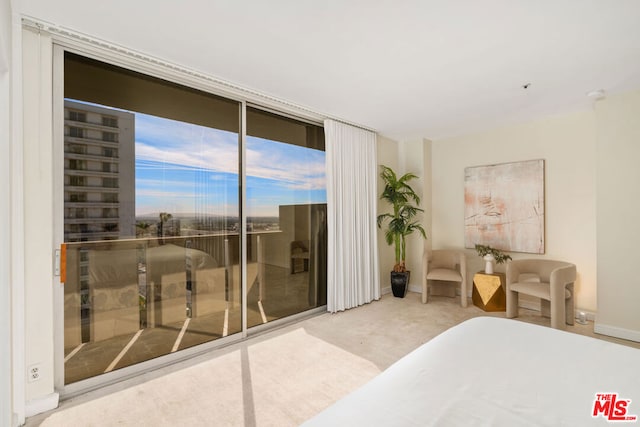 carpeted bedroom featuring access to exterior and floor to ceiling windows