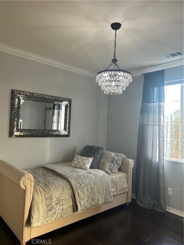 bedroom with ornamental molding and dark hardwood / wood-style flooring