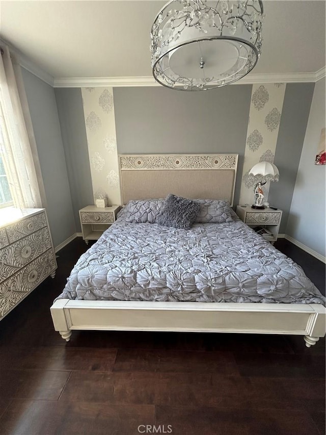 bedroom with ornamental molding and dark hardwood / wood-style flooring