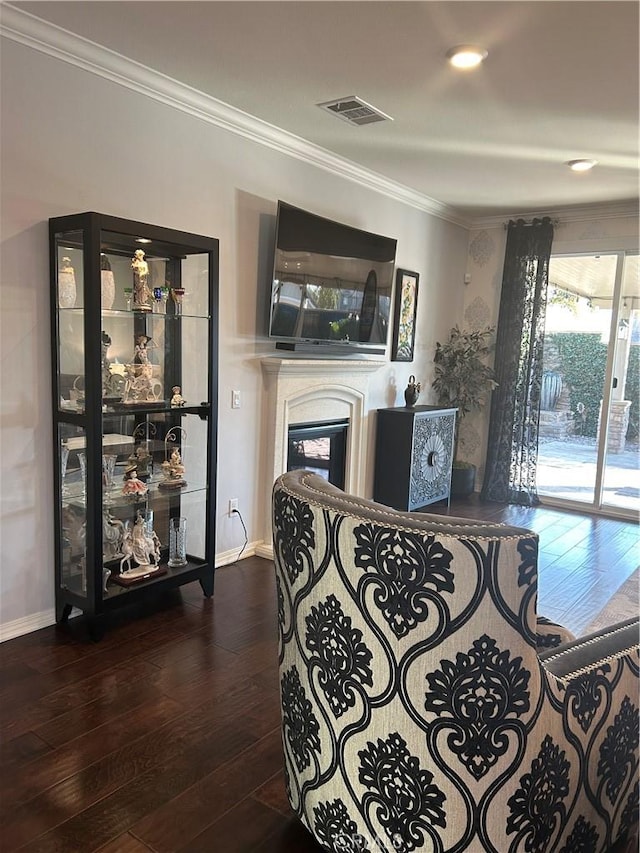 living room with wood-type flooring and ornamental molding