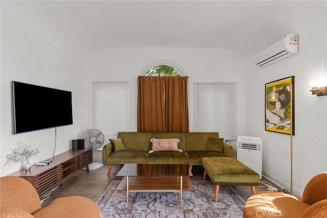 living room with wood-type flooring and a wall mounted AC