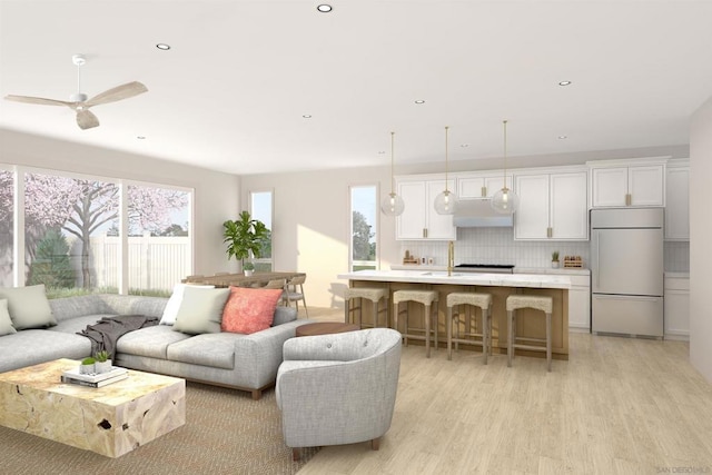 living room featuring ceiling fan and light wood-type flooring