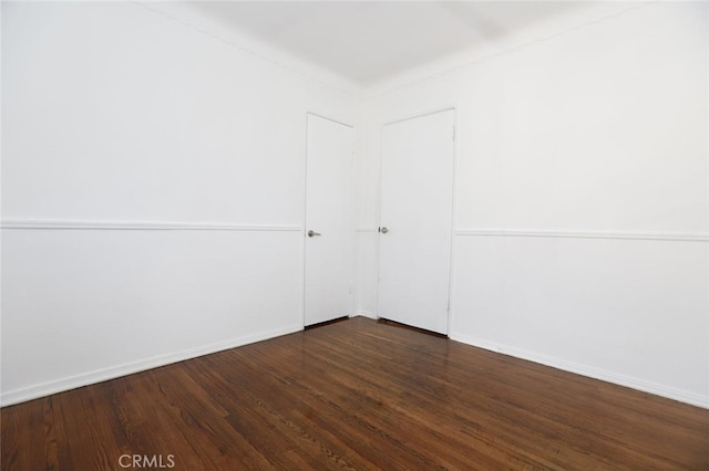 empty room with dark wood-type flooring