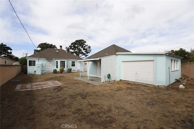 back of house featuring a garage