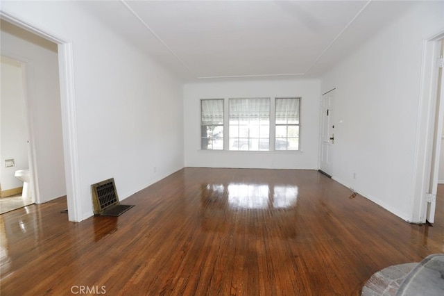 unfurnished living room featuring dark wood-type flooring