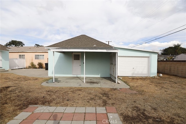 rear view of house with a garage