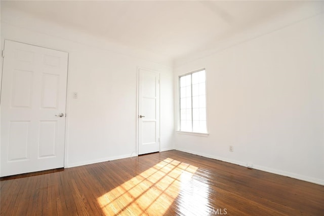 unfurnished room with hardwood / wood-style flooring