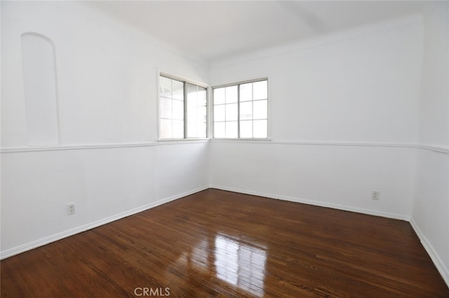 unfurnished room with dark wood-type flooring