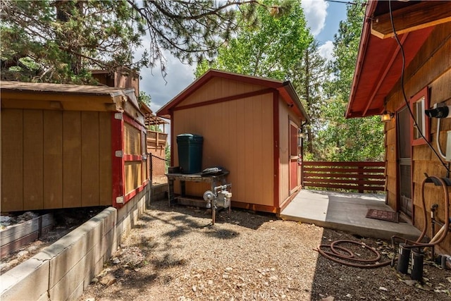 view of side of property featuring a storage unit