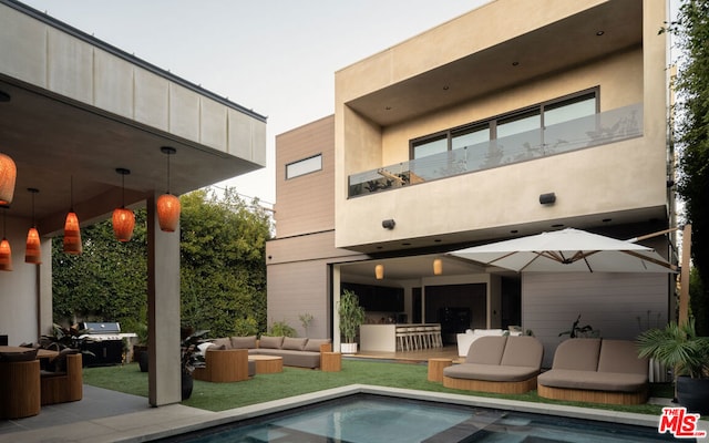 rear view of house featuring an outdoor hangout area and a patio