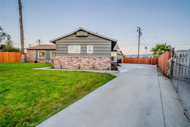 view of side of property with a yard