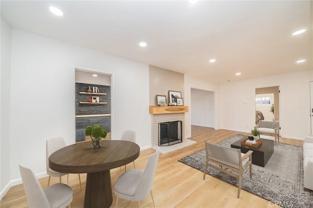 living room featuring hardwood / wood-style flooring and a large fireplace