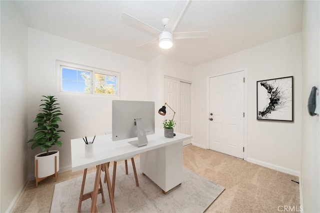 office space with light colored carpet and ceiling fan