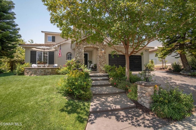 view of front of home with a garage and a front lawn