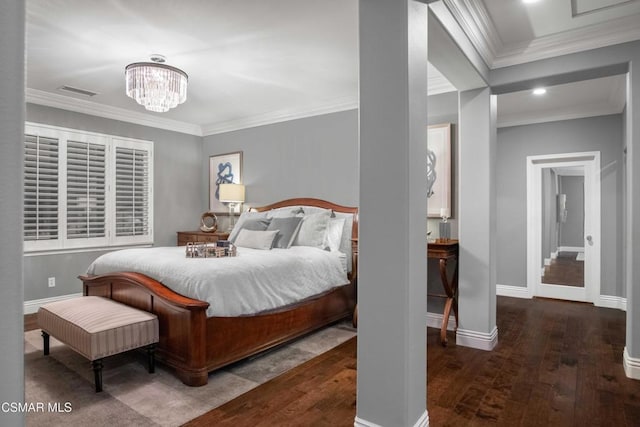 bedroom featuring crown molding, dark hardwood / wood-style floors, and a notable chandelier