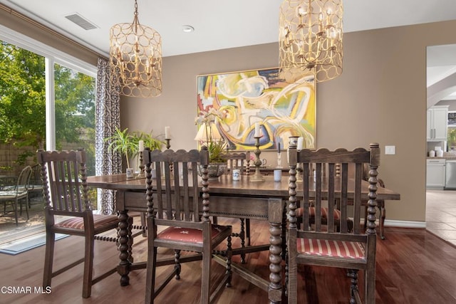 dining area with an inviting chandelier and hardwood / wood-style flooring