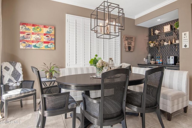 dining room featuring crown molding, light tile patterned floors, and a chandelier