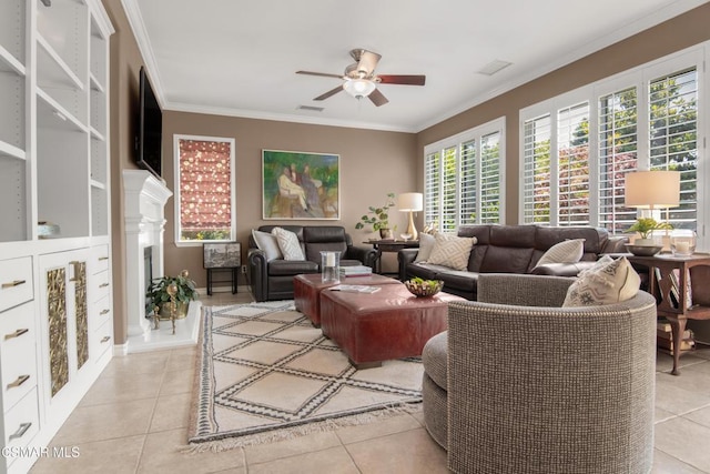 living room featuring ceiling fan, ornamental molding, and light tile patterned floors