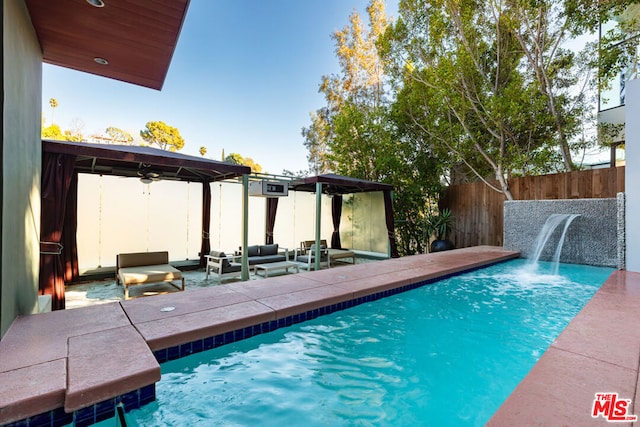 view of swimming pool featuring a pergola, outdoor lounge area, and pool water feature