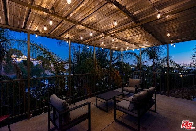 patio terrace at dusk featuring an outdoor hangout area