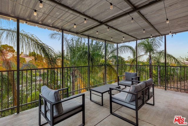 sunroom / solarium featuring rail lighting