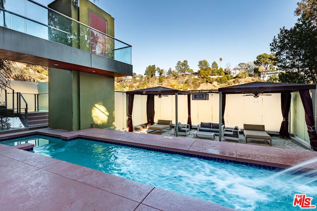 view of swimming pool with a gazebo, an outdoor hangout area, ceiling fan, and a patio