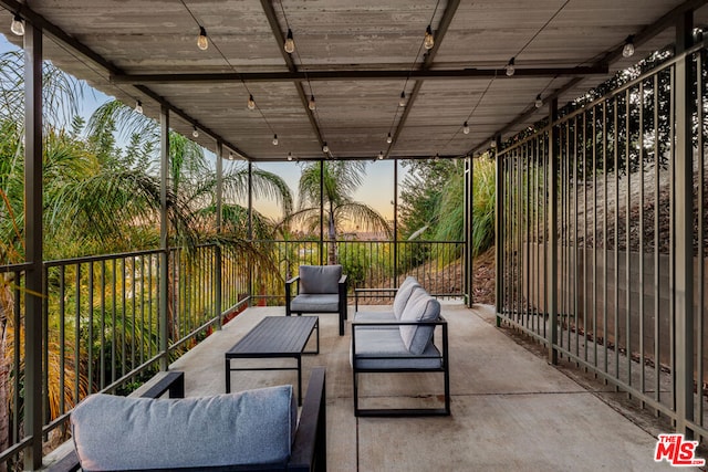 patio terrace at dusk featuring an outdoor living space