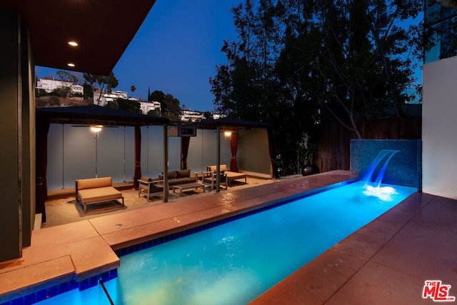 pool at twilight featuring a gazebo, an outdoor living space, and a patio area