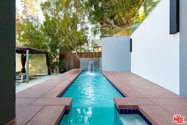 view of pool featuring a patio and pool water feature