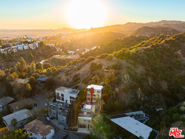 aerial view at dusk featuring a mountain view