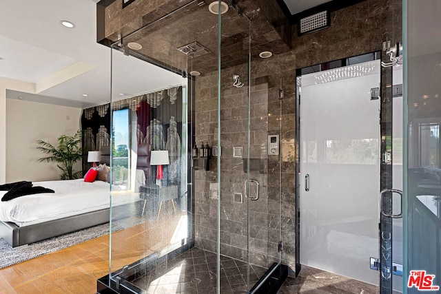 bathroom featuring a shower with shower door