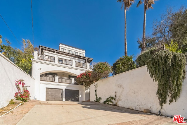 view of front facade with a garage and a balcony