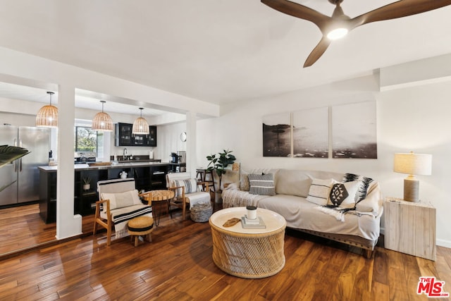 living room featuring dark wood-type flooring, radiator, and ceiling fan