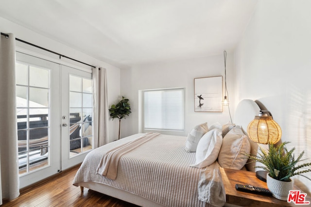 bedroom featuring multiple windows, access to outside, french doors, and wood-type flooring