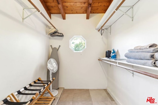 walk in closet featuring beam ceiling