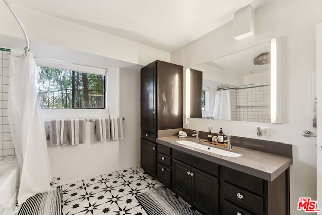 bathroom featuring vanity and shower / bathtub combination with curtain