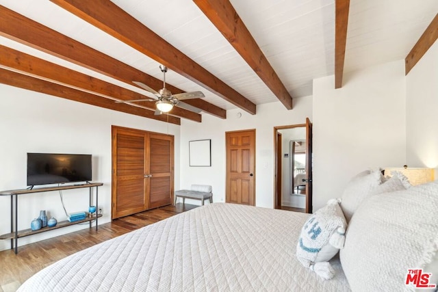 bedroom with hardwood / wood-style floors, a closet, beamed ceiling, and ceiling fan