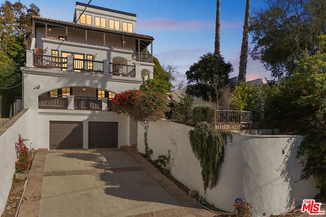 view of front of house featuring a balcony and a garage