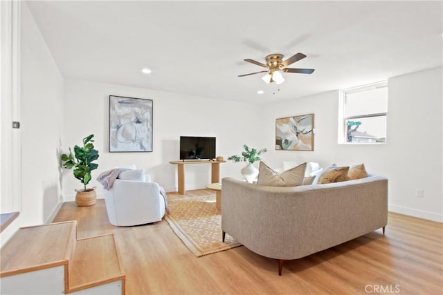 living room with hardwood / wood-style flooring and ceiling fan