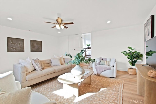 living room featuring ceiling fan and light wood-type flooring