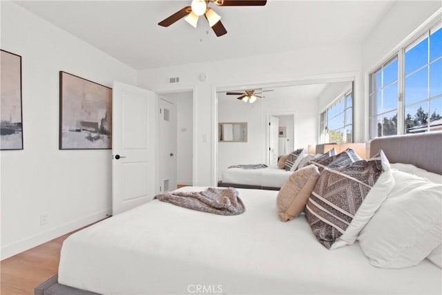 bedroom featuring hardwood / wood-style flooring and ceiling fan