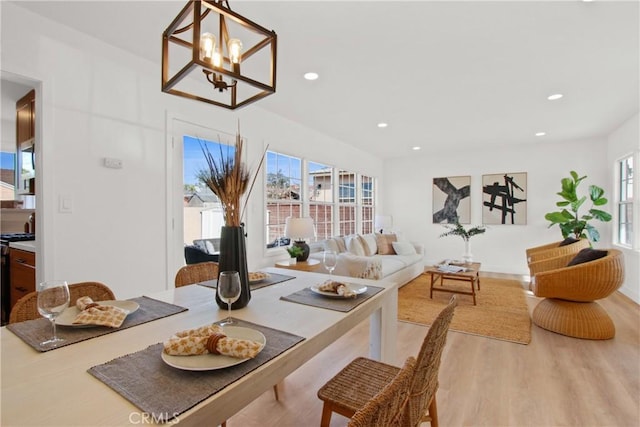 dining area with an inviting chandelier and light wood-type flooring