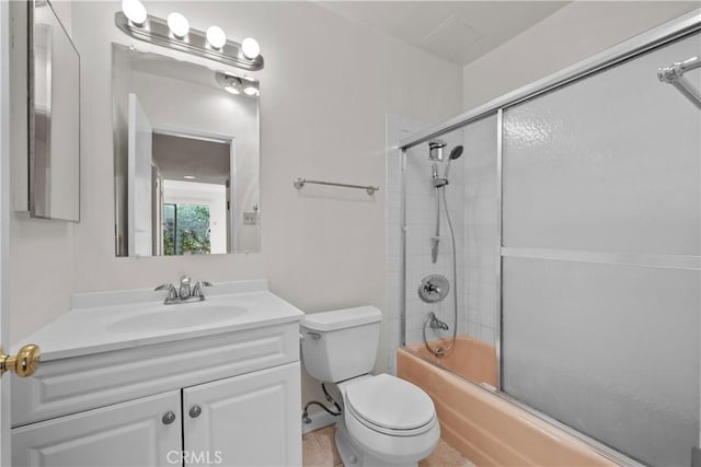 full bathroom with bath / shower combo with glass door, vanity, tile patterned floors, and toilet