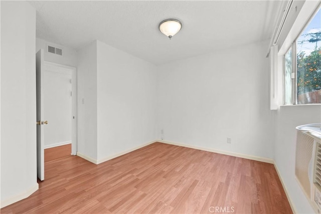 unfurnished room with light hardwood / wood-style floors