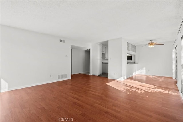 unfurnished living room featuring hardwood / wood-style floors and ceiling fan