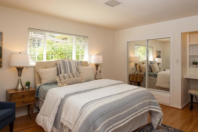 bedroom with hardwood / wood-style flooring and a closet