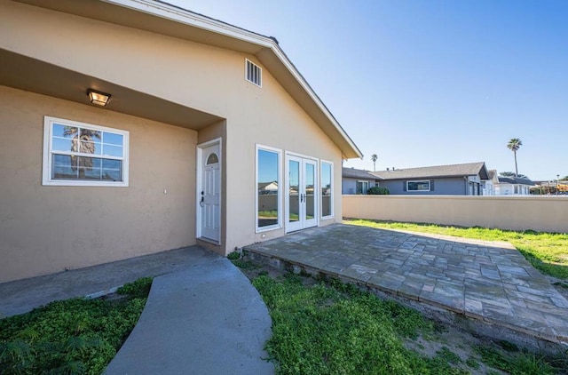 entrance to property featuring a patio area