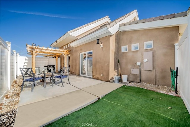 back of property with a patio, a yard, and a pergola