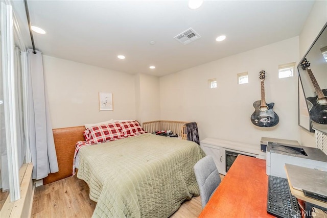 bedroom with light hardwood / wood-style floors